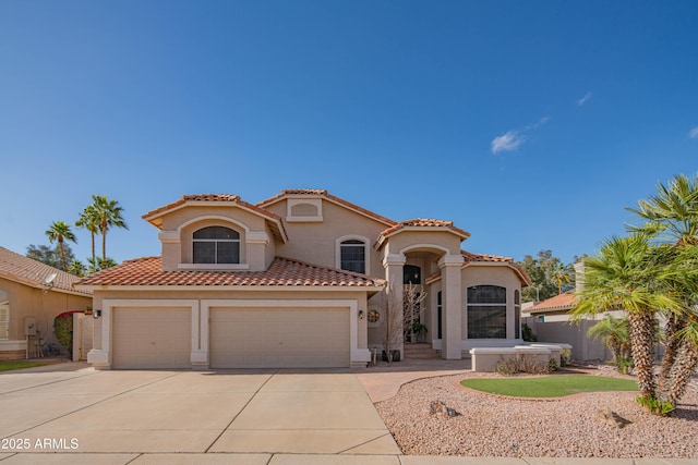 mediterranean / spanish home featuring concrete driveway, a tiled roof, an attached garage, and stucco siding