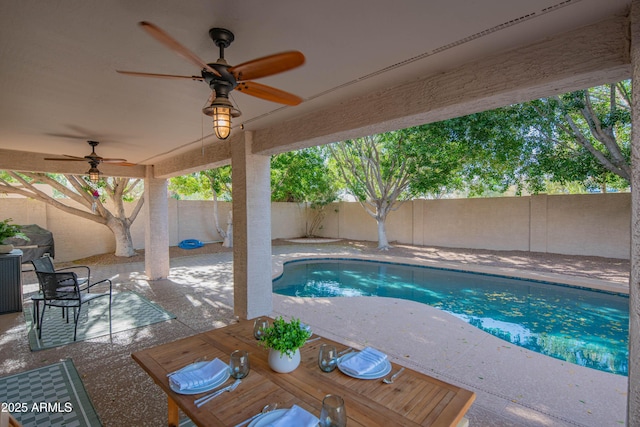 view of swimming pool featuring a patio, a fenced backyard, a ceiling fan, and a fenced in pool