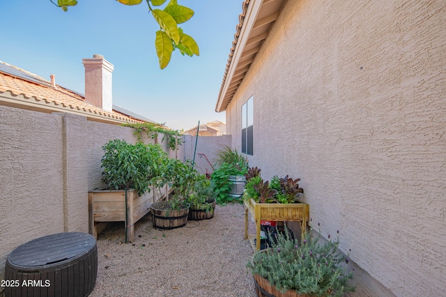 view of yard with a garden, fence, and cooling unit