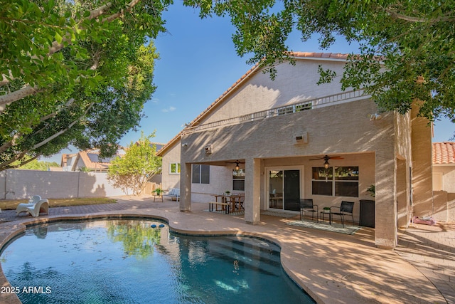 view of swimming pool featuring ceiling fan, a patio area, fence, and a fenced in pool