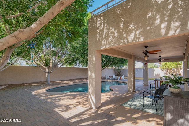 view of swimming pool with a patio area, a fenced backyard, ceiling fan, and a fenced in pool