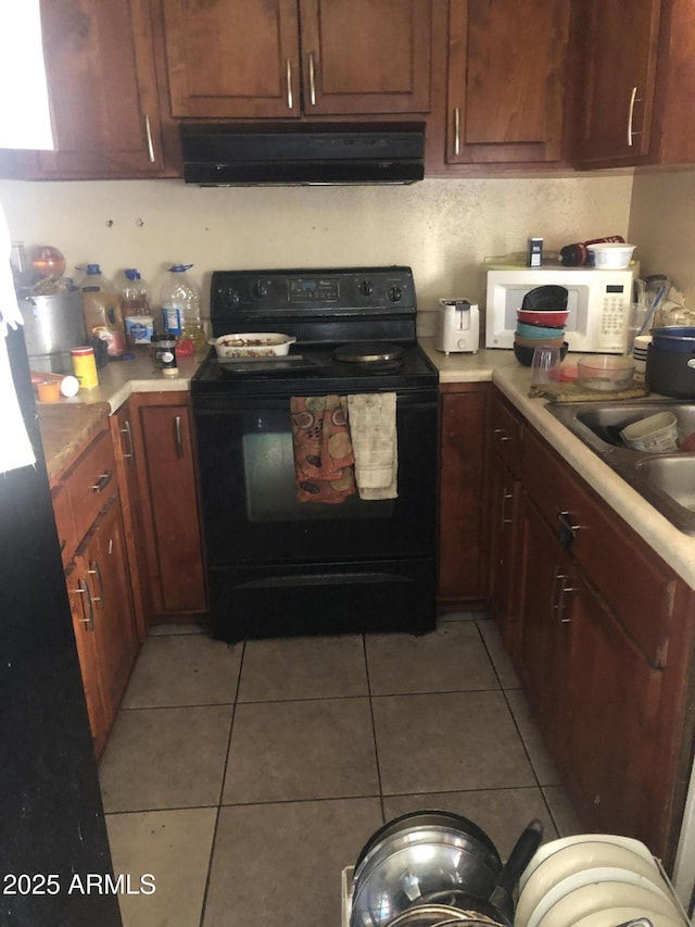 kitchen with black / electric stove, sink, light tile patterned floors, and exhaust hood