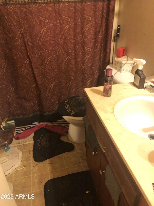 bathroom featuring tile patterned floors, vanity, and toilet