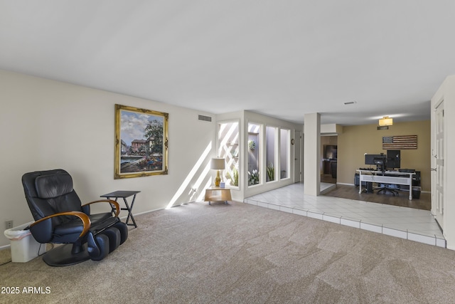 living area with carpet flooring, visible vents, and tile patterned floors