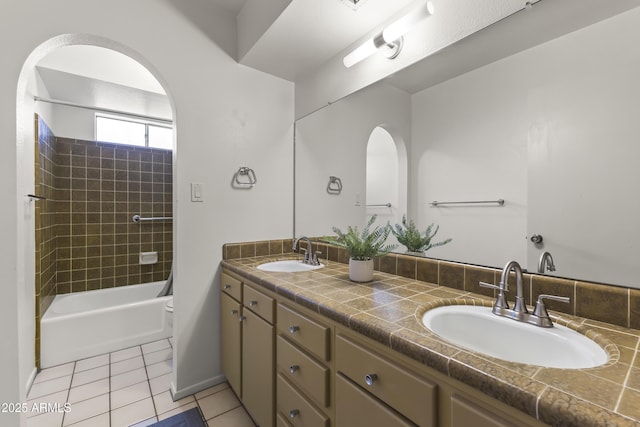 bathroom with double vanity, tile patterned flooring, a sink, and toilet