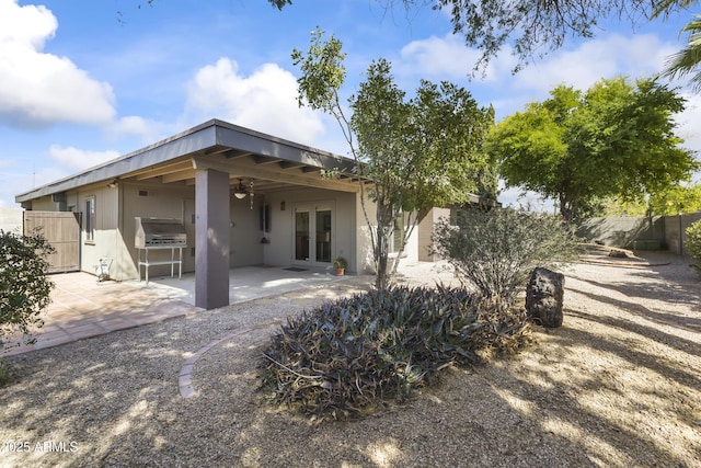 rear view of house featuring french doors, a patio area, fence, and ceiling fan