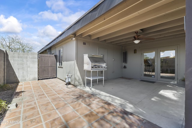 view of patio with french doors, a grill, fence, and ceiling fan