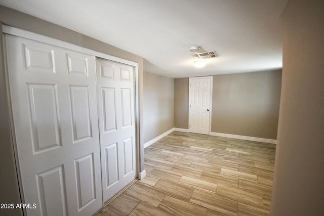 corridor with light hardwood / wood-style flooring