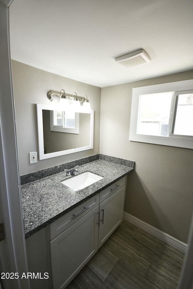 bathroom featuring vanity and wood-type flooring