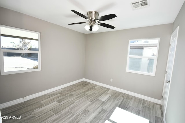 spare room featuring ceiling fan and light hardwood / wood-style flooring