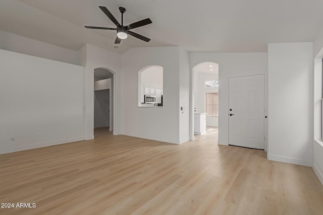 unfurnished room featuring ceiling fan, lofted ceiling, and light wood-type flooring