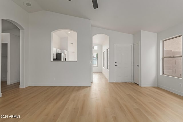 unfurnished room with light wood-type flooring, vaulted ceiling, and ceiling fan