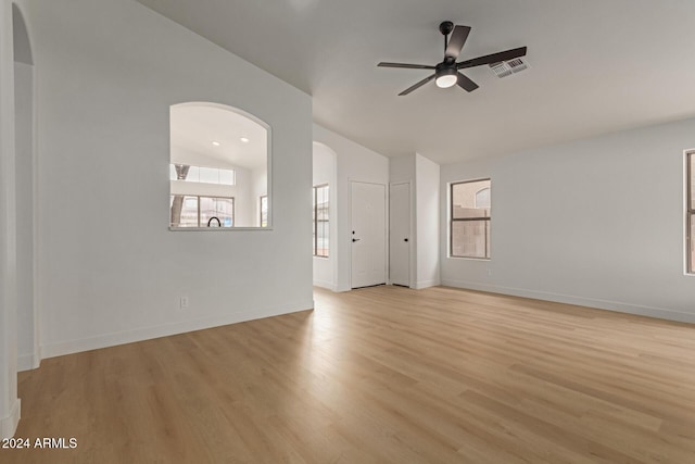 unfurnished living room with ceiling fan, lofted ceiling, and light hardwood / wood-style flooring