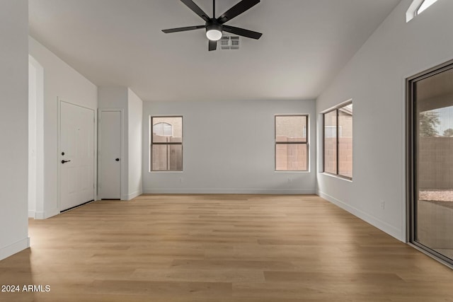 empty room with ceiling fan and light hardwood / wood-style floors