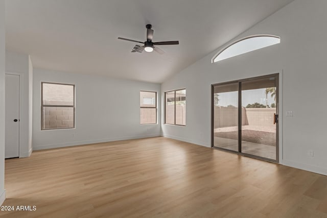 empty room featuring ceiling fan, light hardwood / wood-style floors, and vaulted ceiling