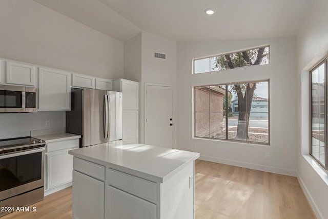 kitchen featuring white cabinets, appliances with stainless steel finishes, and a center island