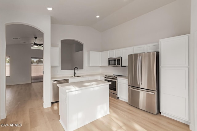 kitchen with white cabinetry, sink, a center island, ceiling fan, and appliances with stainless steel finishes