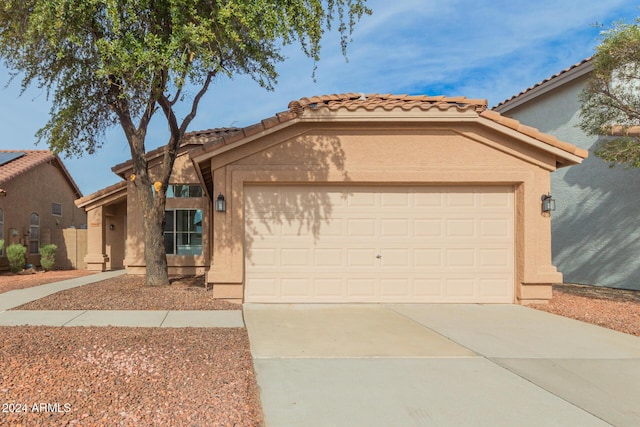 mediterranean / spanish-style home featuring a garage