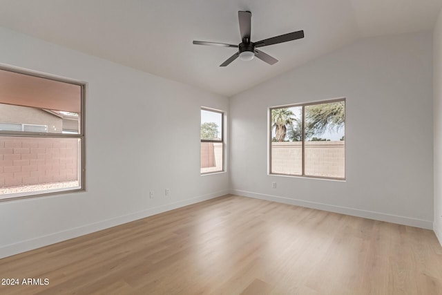 empty room featuring ceiling fan, light hardwood / wood-style floors, and vaulted ceiling