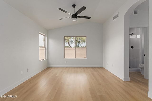 empty room featuring ceiling fan, lofted ceiling, and light wood-type flooring