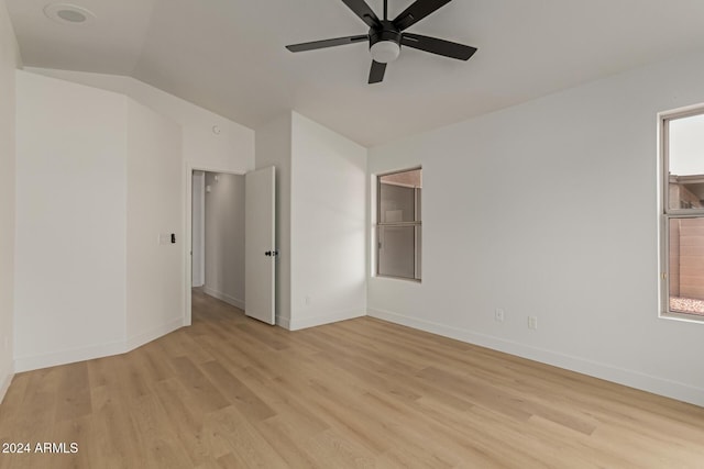 unfurnished room with a wealth of natural light, light hardwood / wood-style floors, ceiling fan, and lofted ceiling