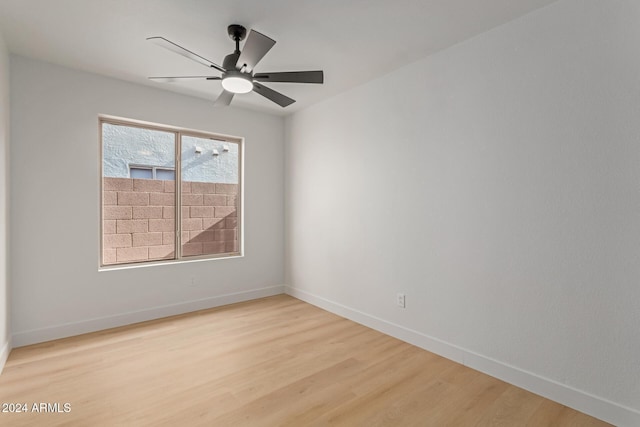 empty room featuring ceiling fan and light hardwood / wood-style flooring