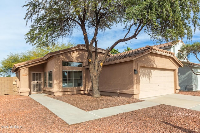 mediterranean / spanish-style home with a garage