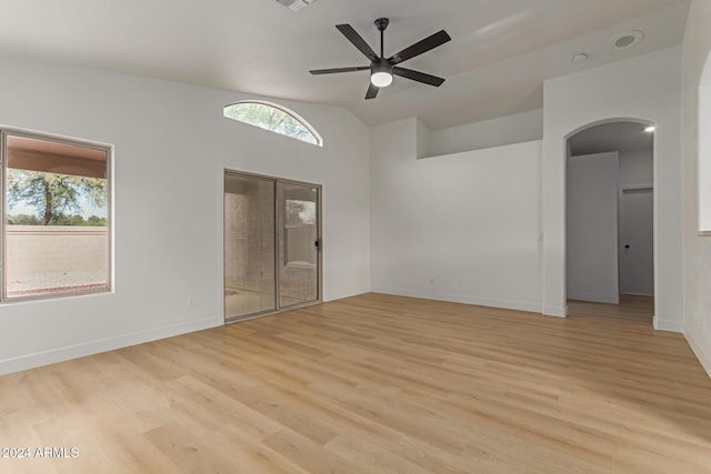 unfurnished room with ceiling fan, light hardwood / wood-style floors, and lofted ceiling