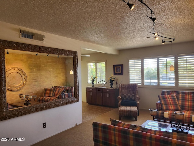 8220 E Garfield St Unit M214, Scottsdale, AZ 85257 - living area with a textured ceiling, visible vents, light colored carpet, and track lighting