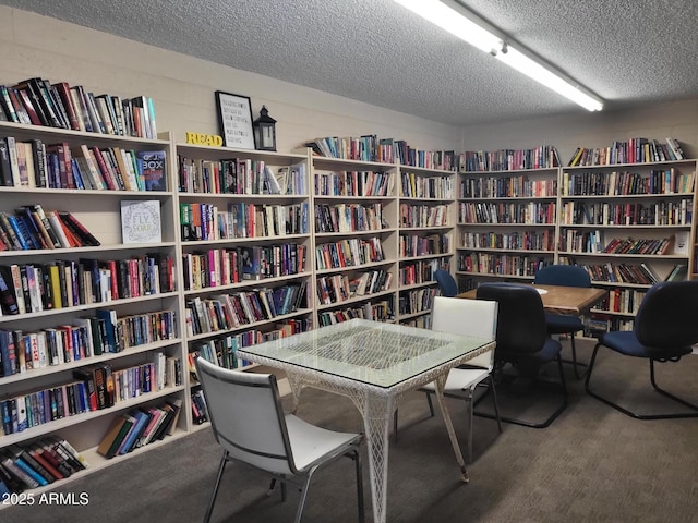 8220 E Garfield St Unit M214, Scottsdale, AZ 85257 - living area featuring a textured ceiling and bookshelves