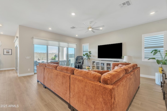 living room featuring visible vents, a ceiling fan, and recessed lighting