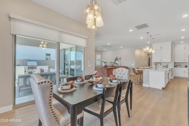 dining room featuring light wood-style flooring, visible vents, baseboards, and recessed lighting