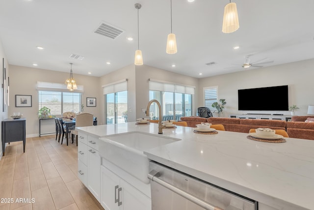 kitchen featuring a sink, visible vents, open floor plan, and dishwasher