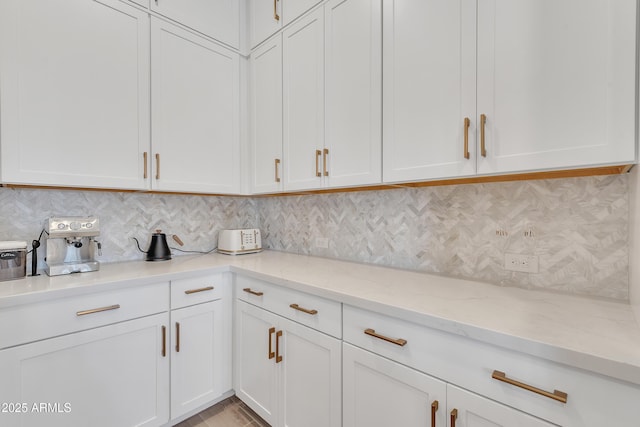 kitchen featuring white cabinetry and decorative backsplash