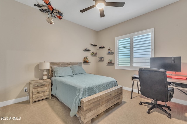 carpeted bedroom with ceiling fan and baseboards