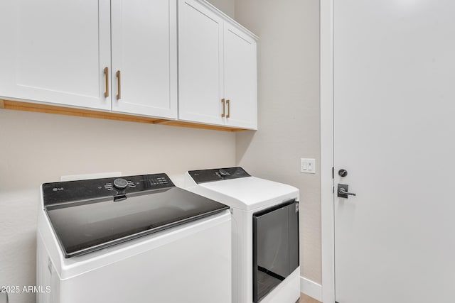 laundry room featuring washing machine and dryer and cabinet space