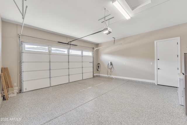 garage with baseboards and a garage door opener