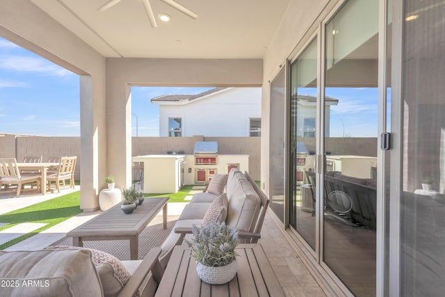 balcony featuring a ceiling fan, a patio area, grilling area, and an outdoor hangout area