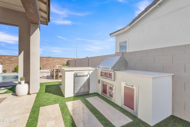 view of patio / terrace featuring exterior kitchen, a fenced in pool, a fenced backyard, and a grill