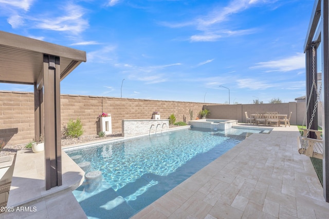 view of swimming pool with a pool with connected hot tub, a fenced backyard, and a patio