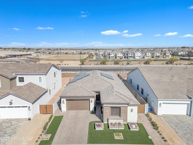 view of front of home featuring fence, decorative driveway, a residential view, stucco siding, and a front lawn