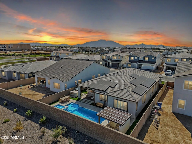 drone / aerial view featuring a residential view and a mountain view