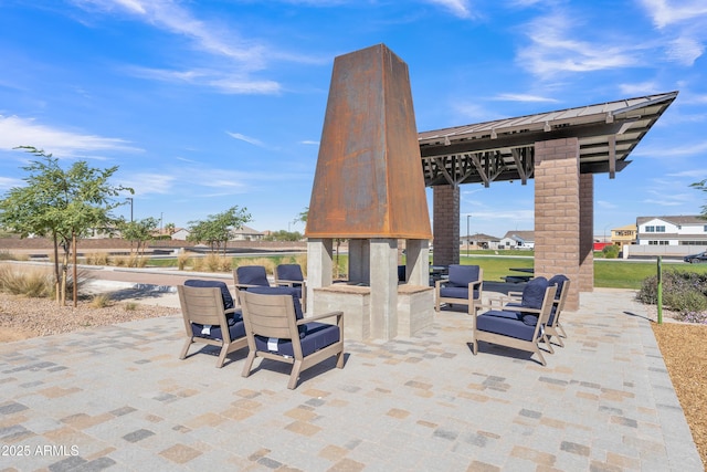 view of patio featuring a gazebo and a multi sided fireplace