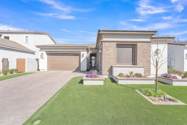 prairie-style home with a garage, driveway, brick siding, and a front lawn