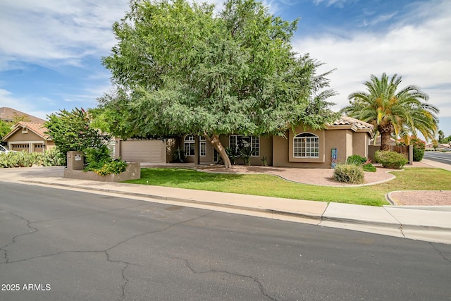 2405 E Lynwood Cir, Mesa, AZ 85213 - obstructed view of property with an attached garage, stucco siding, a front yard, a tile roof, and driveway
