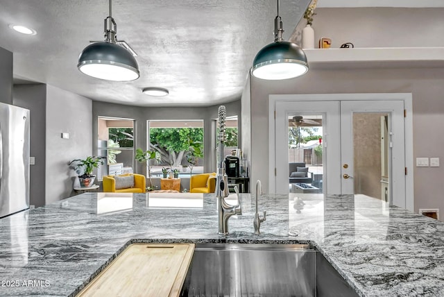 2405 E Lynwood Cir, Mesa, AZ 85213 - kitchen featuring freestanding refrigerator, healthy amount of natural light, french doors, and hanging light fixtures