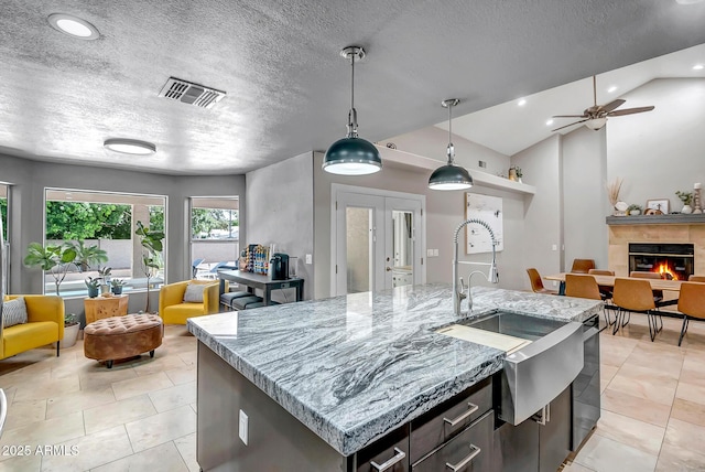 2405 E Lynwood Cir, Mesa, AZ 85213 - kitchen featuring open floor plan, a sink, a ceiling fan, hanging light fixtures, and light stone countertops