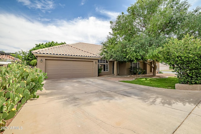 2405 E Lynwood Cir, Mesa, AZ 85213 - view of front of house featuring an attached garage, driveway, stucco siding, and a tile roof
