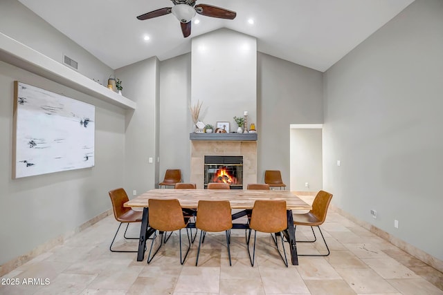 2405 E Lynwood Cir, Mesa, AZ 85213 - dining space featuring a fireplace, a ceiling fan, baseboards, and high vaulted ceiling