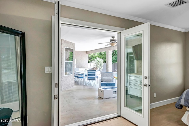 2405 E Lynwood Cir, Mesa, AZ 85213 - doorway with a ceiling fan, ornamental molding, finished concrete flooring, and baseboards